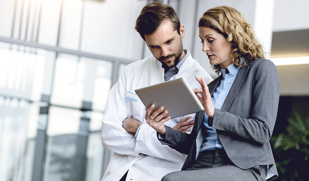 Sales professional talking with a doctor in a medical facility